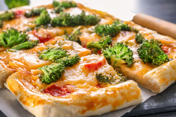 Traditional quiche with broccoli and cheese on table, close up