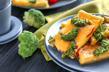 Traditional quiche with broccoli and cheese on plate