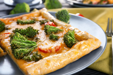 Traditional quiche with broccoli and cheese on plate