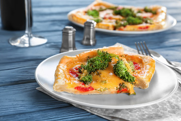 Traditional quiche with broccoli and cheese on plate