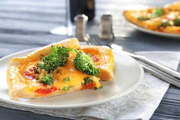 Traditional quiche with broccoli and cheese on plate