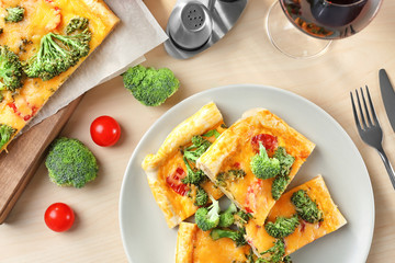 Traditional quiche with broccoli and cheese on plate