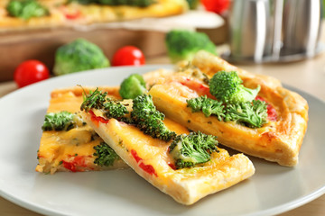 Traditional quiche with broccoli and cheese on plate