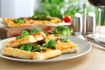 Traditional quiche with broccoli and cheese on plate