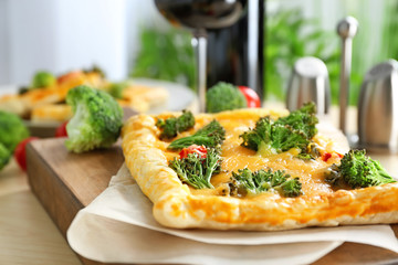 Traditional quiche with broccoli and cheese on board