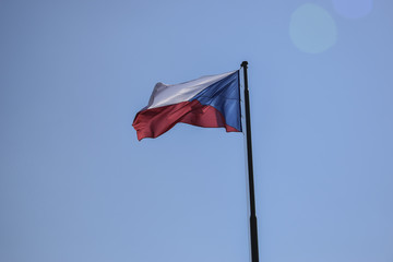 czech flag waving on clear sky with lense reflection