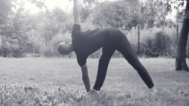 A man doing yoga exercises in the park