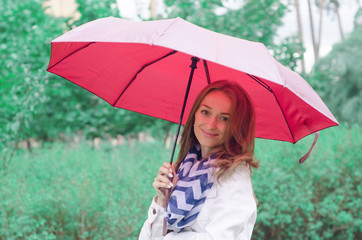 Beautiful young woman on nature park umbrella