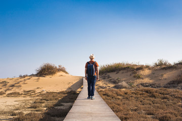 Young hipster man traveling backpacker outdoor. Travel concept.