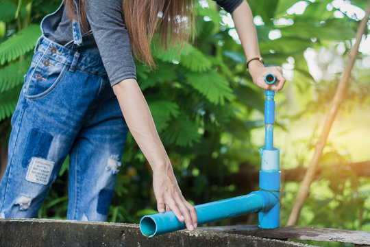 Woman Construction Worker,Repairing A Broken Water Pipe In Garden.