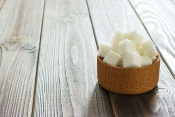 White sugar in bowls on wooden background. Selective focus, horizontal.