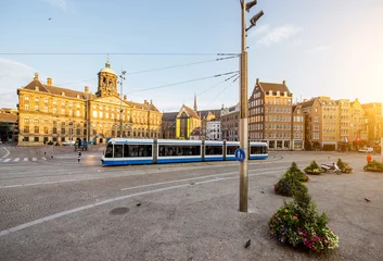 Foto op Plexiglas Morning view on the Dam square with Royal palace and tram in Amsterdam city during the sunny weather © rh2010