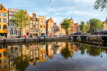 Morning view on the beautiful buildings and water channel in Amsterdam