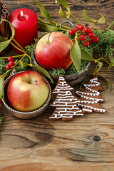 Christmas decor with red apples, moss and mistletoe twigs.