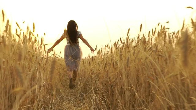 Pretty Girl In The Dress Is Running Across The Field.