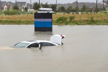 Sedan car swamped by flood water in Humble, Texas, US by Harvey Tropical Storm. Flooded car under...