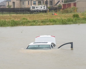 Sedan car swamped by flood water in Humble, Texas, US by Harvey Tropical Storm. Flooded car under...