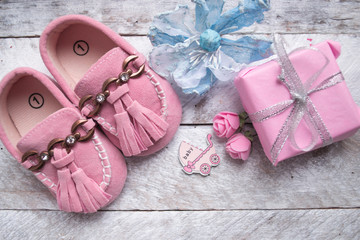 Little girlie baby shoes on a wood