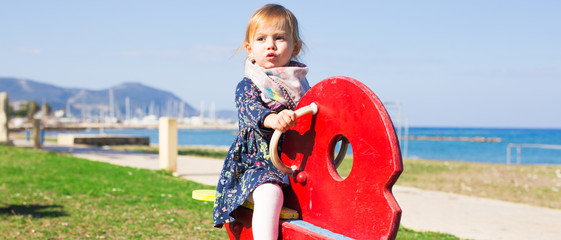 Active little girl on playground