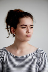 emotions, people, beauty and lifestyle concept - The doubting woman on gray background