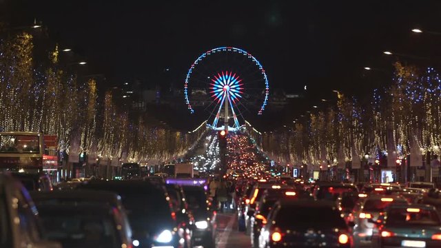 Paris - France - December 2016. Traffic jam on Champs Elysees. Ferris Wheel, Egyptian Obelisk background. Christmas Night light.