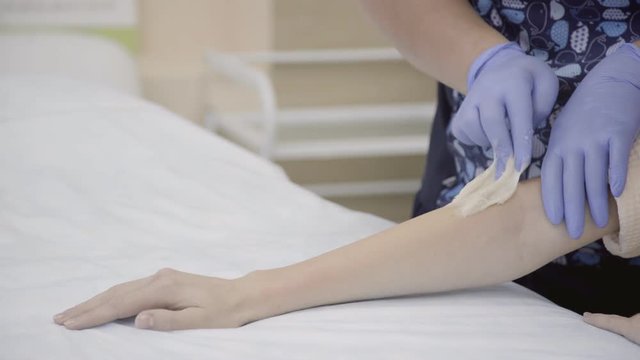 Beautician gloves sharply pulls wax hands during depilation. During the session in the spa the palms quickly remove unwanted hair with sticky mass.