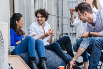 Team of Creative industries agency during lunch at office balcony