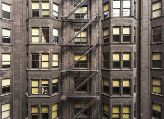 Fototapeta na wymiar Side of brick building with fire escape