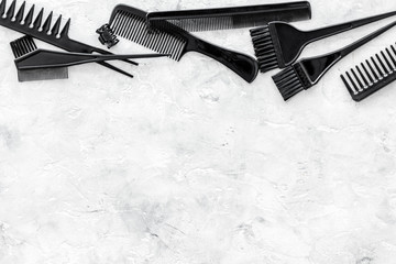 hairdresser working desk with combs, tools for hair styling on gray stone desk background top view mock up