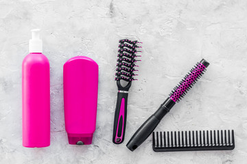 beauty salon pink work tools with comb for hair dress and coloring on stone background top view mock up