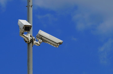 Security cameras on blue sky background