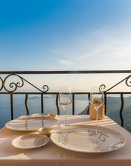 Empty dining table with stunning views overlooking the French Riveira on a sunny day