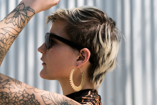 Side view of young woman with tattoo