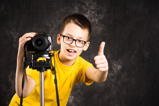 Young photographer with camera on a tripod