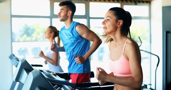 Group of friends exercising on treadmill machine