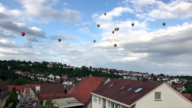 colorful hot air balloons over village