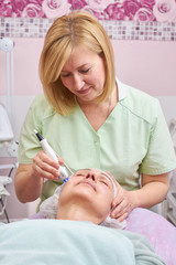 Obraz na płótnie Canvas Mature female in cosmetology clinic. Radio frequency skin tightening procedure.