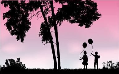 Silhouettes of children with balloon.