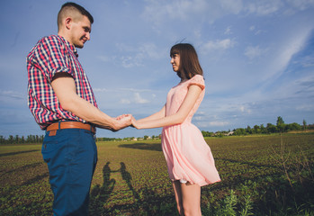 Happy couple on vacation. Lovers are laughing. Happy guy and girl. Lovers enjoy each other in the evening park.