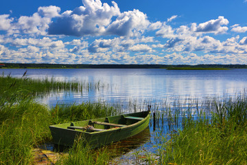 Obraz premium The wooden boat on the river bank