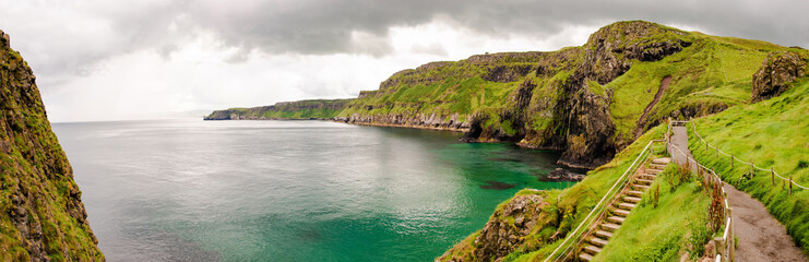 Cliffs of Carrick-a-rede rope bridge in Ballintoy, Co. Antrim. Landscape of Northern Ireland.Traveling through the Causeway Coastal Route. 