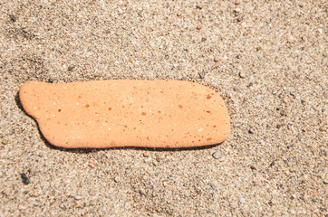 blank stone lying on a sandy beach