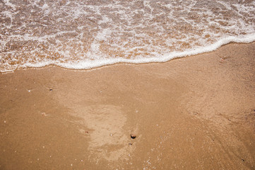 Fototapeta na wymiar Sea beach in with white foam wave