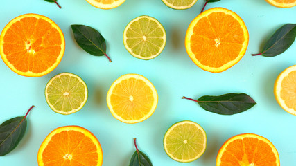Fototapeta na wymiar Mixed citrus fruit on aqua blue table