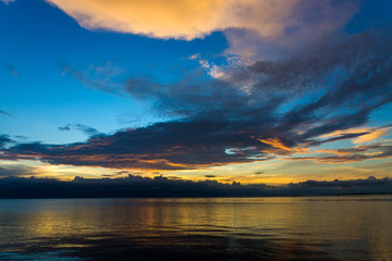 Fototapeta na wymiar Sunset sky with dark cloud on the lake.