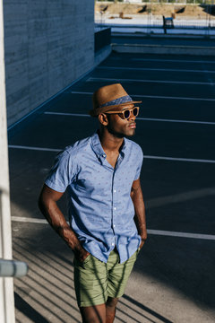 Stylish black man posing at street
