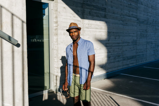 Stylish black man posing at street