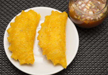 Colombian empanada with spicy sauce