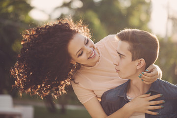 Fototapeta premium Teenagers in park at sunset