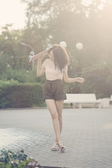 Girl teenager with curly hair and skateboard